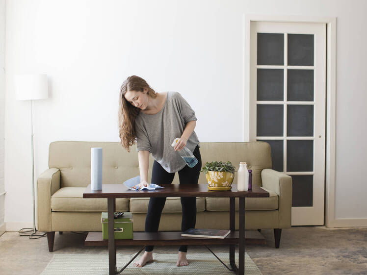 woman cleaning coffee table