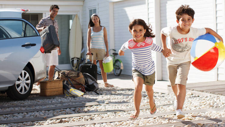 Family packing SUV for a trip