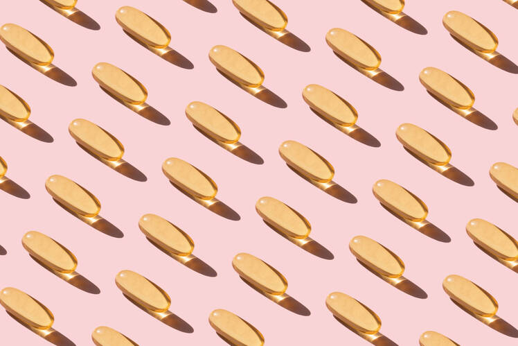 pill capsules on pink background