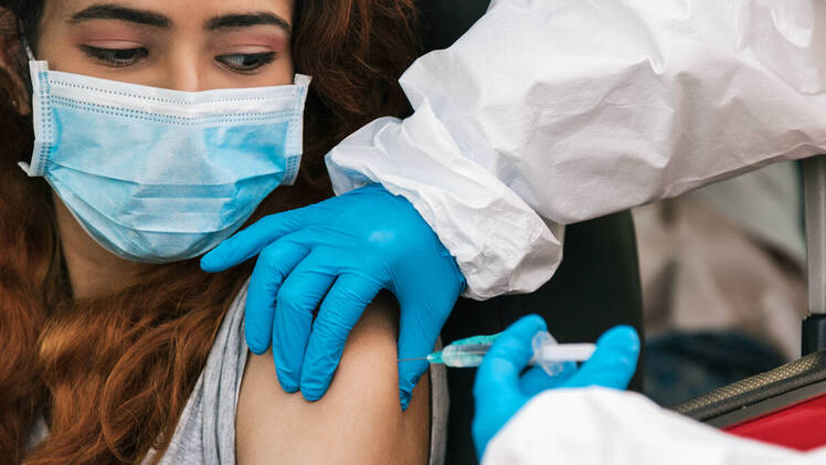 Woman getting drive-thru covid vaccin