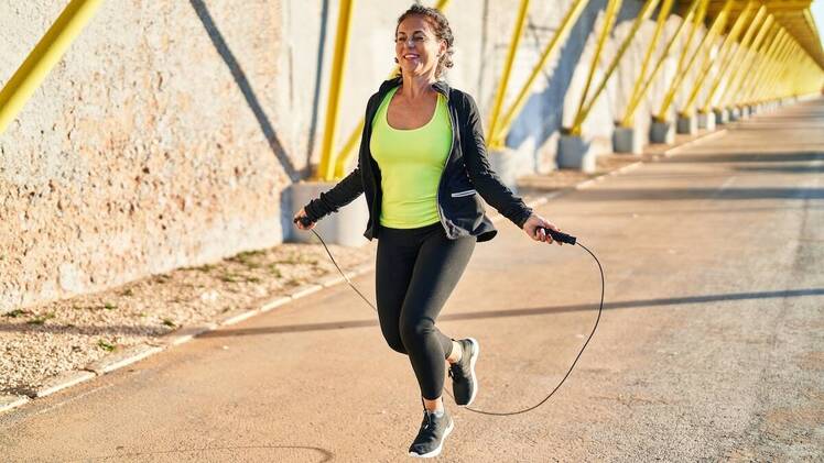 Woman jumping rope outside