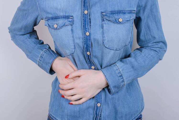 Woman holding her stomach in pain