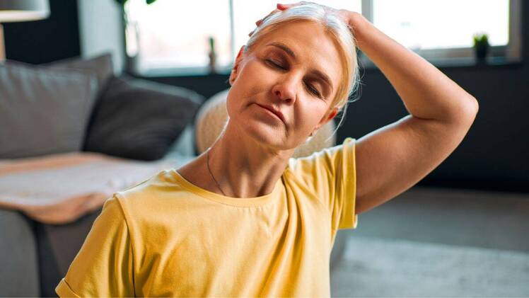 woman stretching to relieve pinched nerve in neck