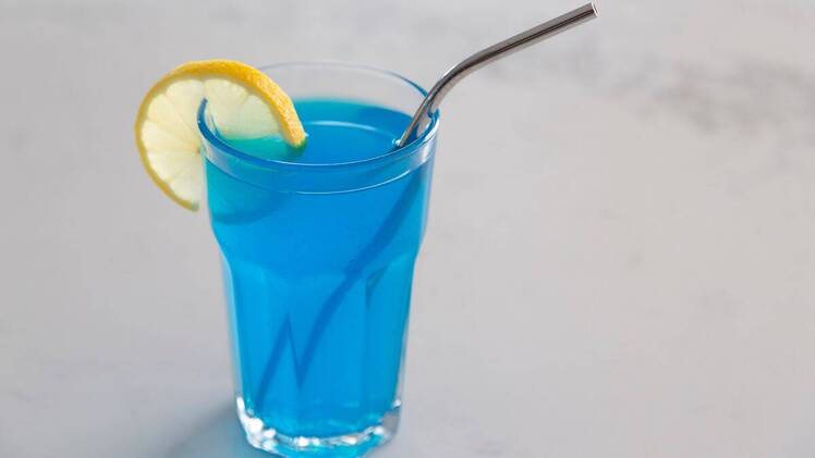 blue tonic for weight loss in a glass with straw