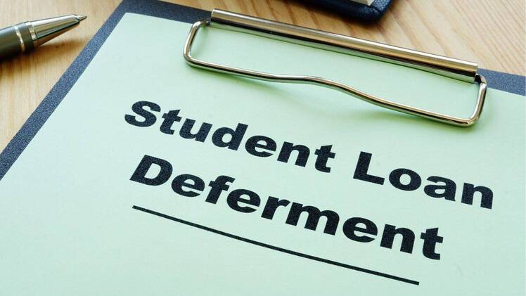 Student loan deferment application on clipboard