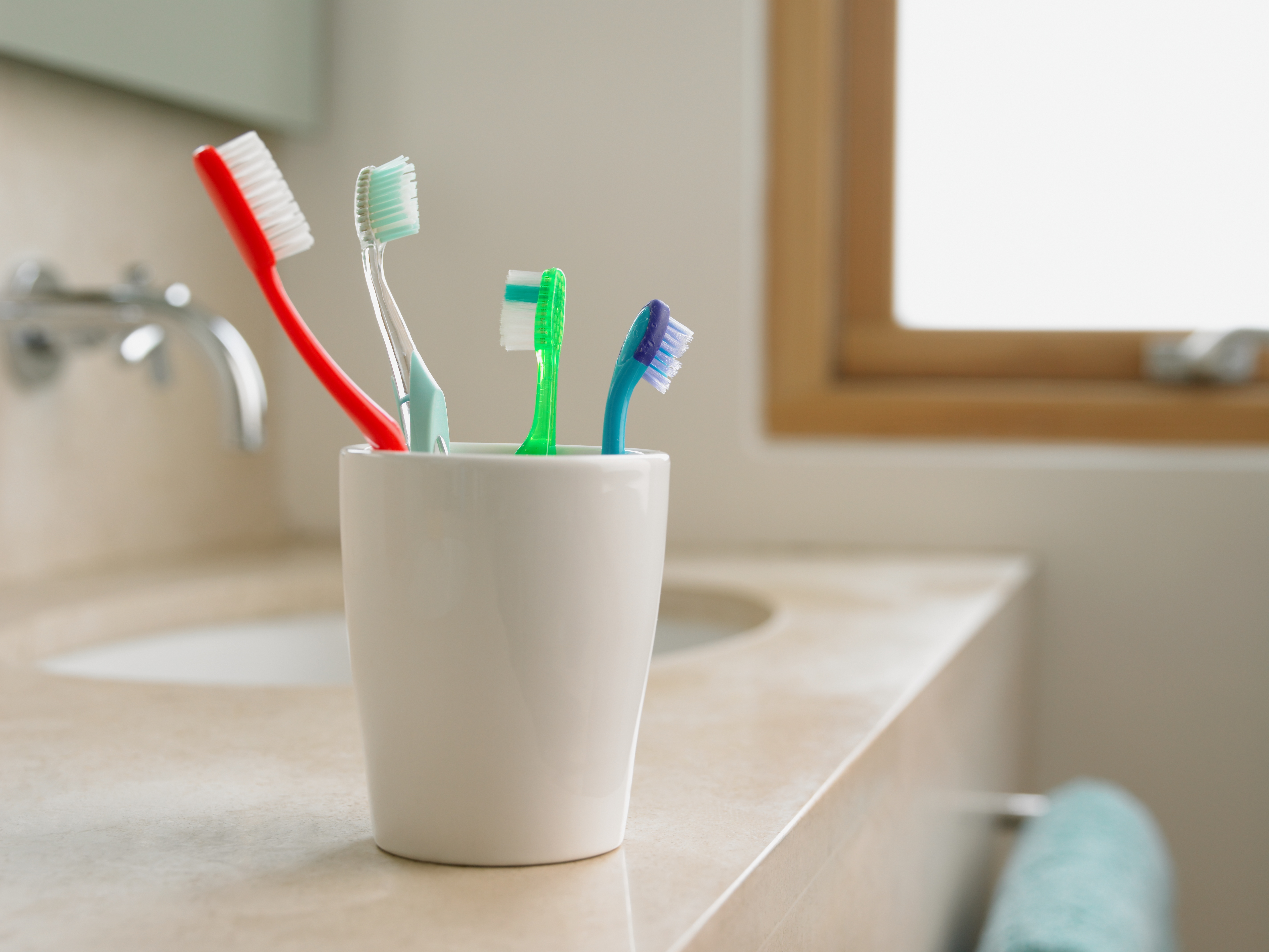 Your Toothbrush Is Teeming With Bacteria: Dentists Share How to Clean It