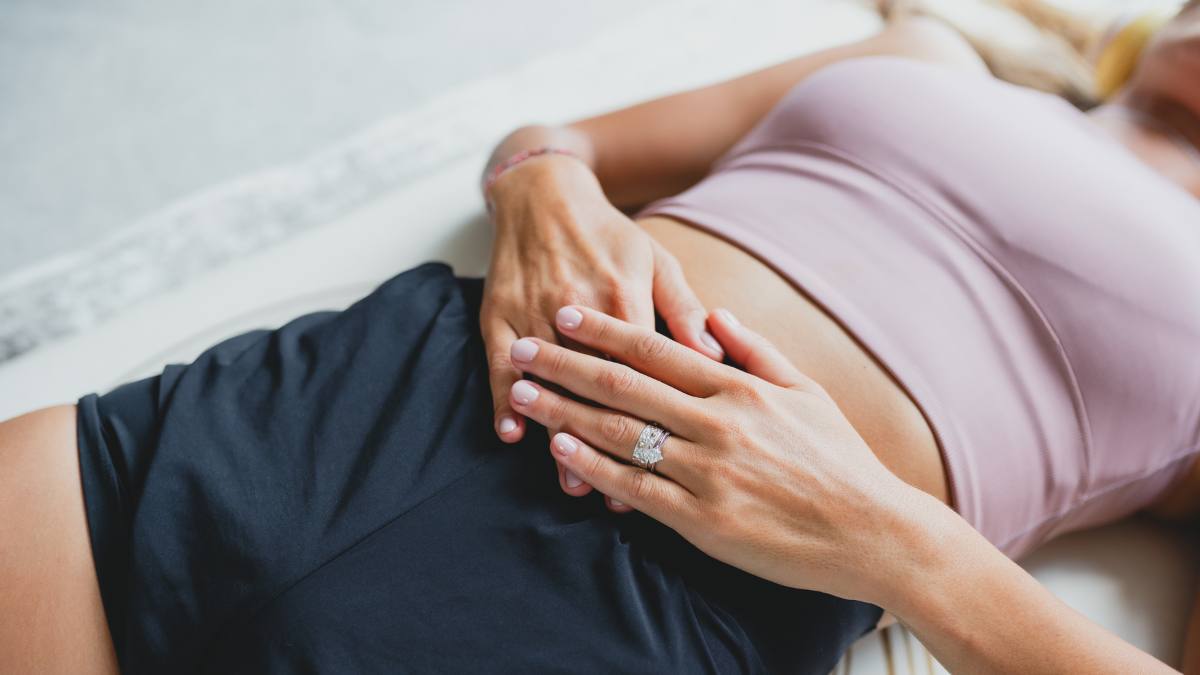 Woman with hands on her stomach