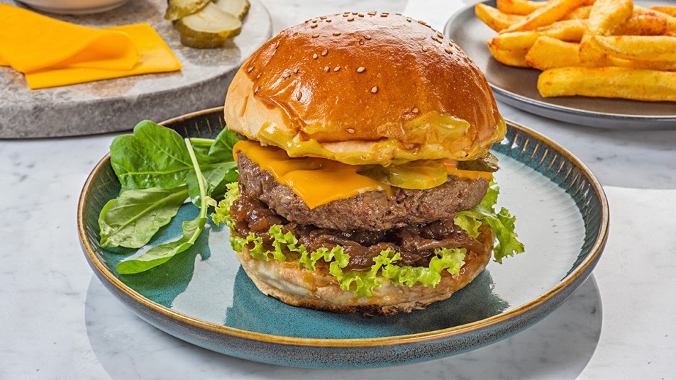 A burger on a plate as part of a guide on how to reheat it