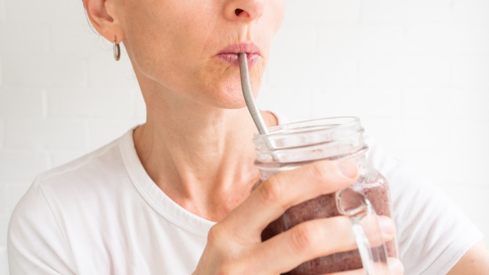 https://www.firstforwomen.com/wp-content/uploads/sites/2/2022/11/mature-woman-sipping-out-of-a-metal-straw-causing-wrinkles-around-her-mouth.jpg?w=953