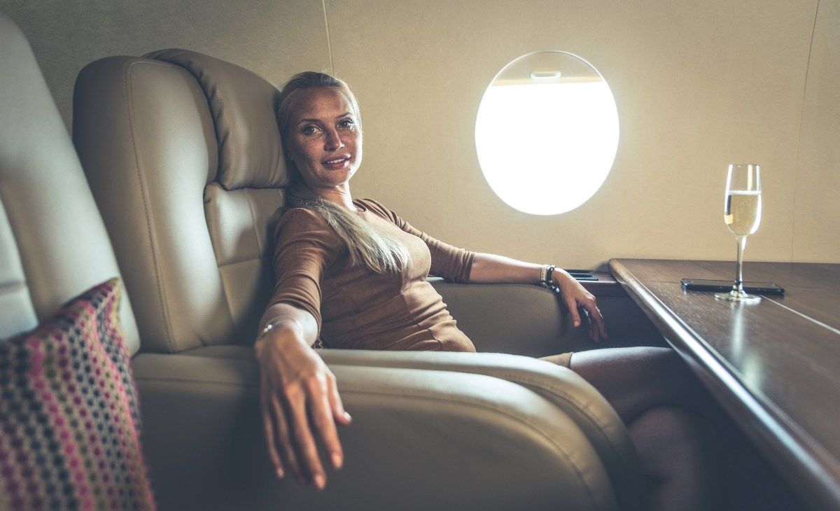 Wealthy woman smiling on a private jet