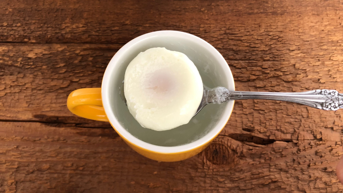https://www.firstforwomen.com/wp-content/uploads/sites/2/2023/03/poached-egg-in-yellow-cup.png