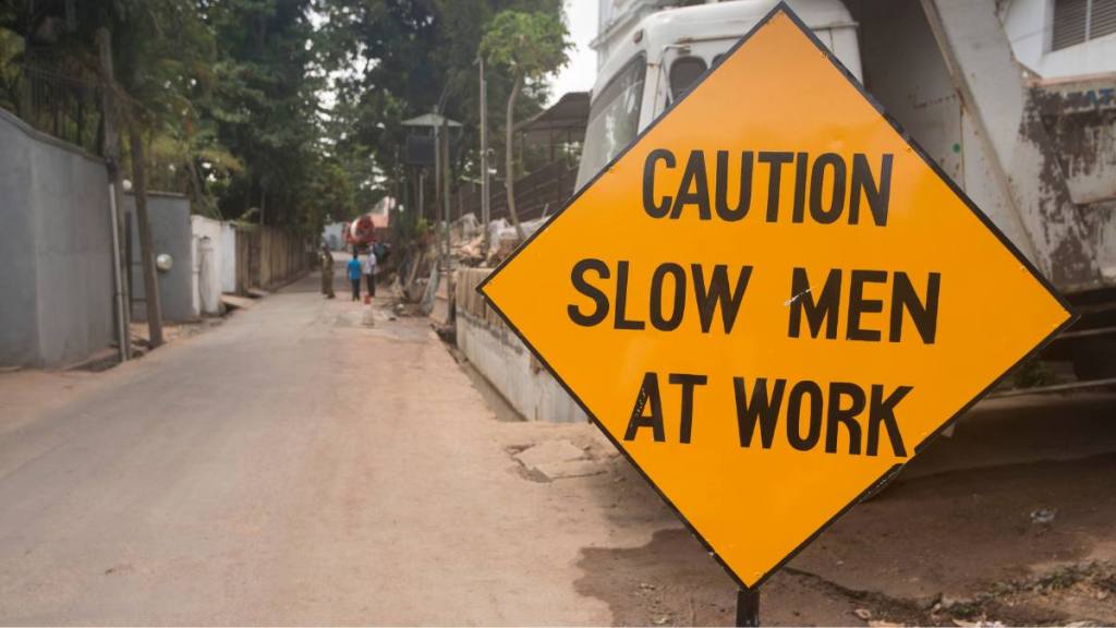 A street warning sign Caution Slow Men at Work sign which appears humorous as it reads that the men are Slow Men (Funny road signs )