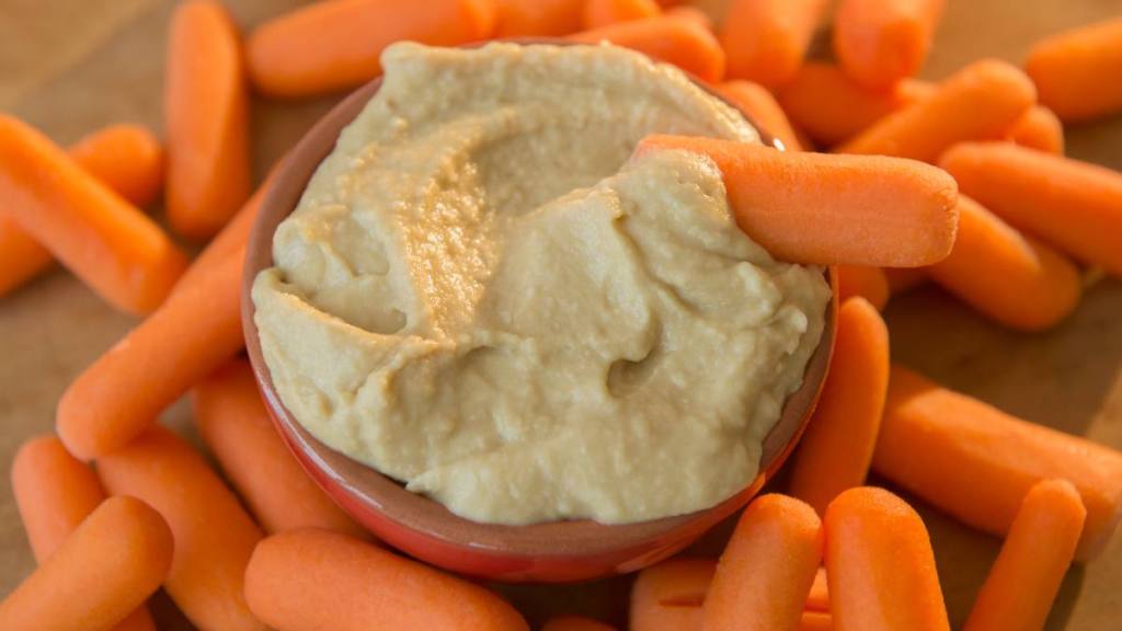 what to eat on ozempic: Studio shot of hummus and baby carrots