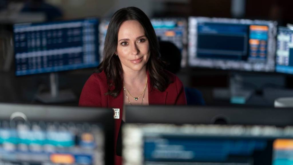 woman looking over computers smiling; jennifer love hewitt movies and tv shows