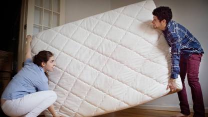 Couple moving a mattress