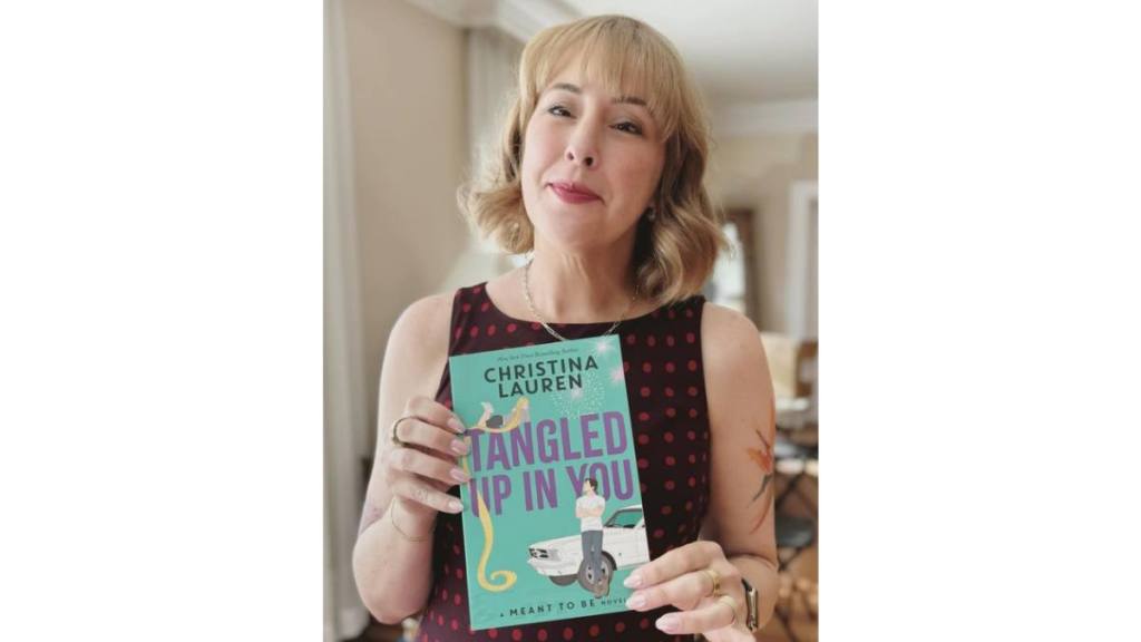 Lauren Billings with a copy of 'Tangled up in You' new christina lauren book