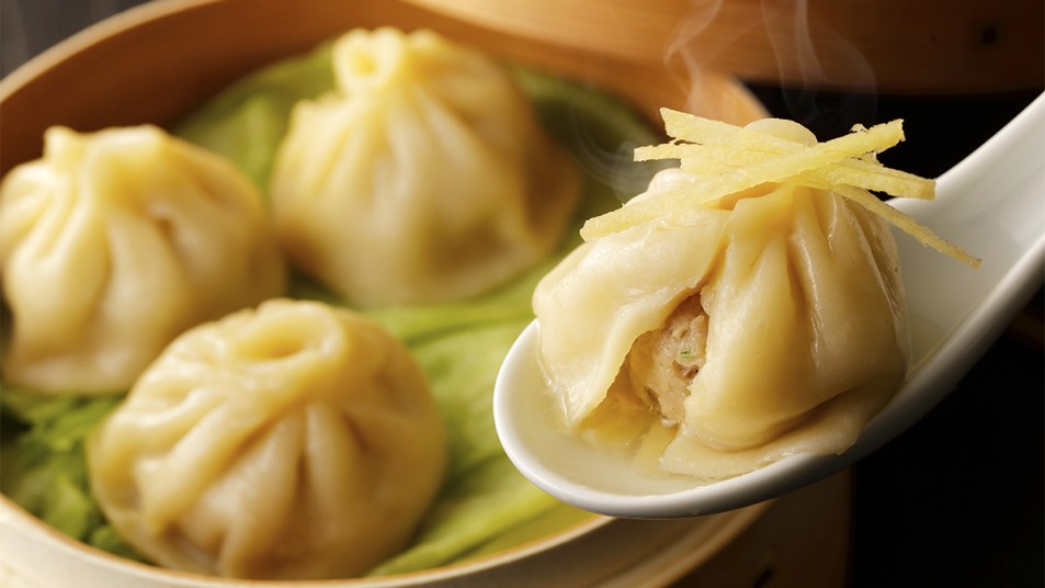 An open soup dumpling on a spoon