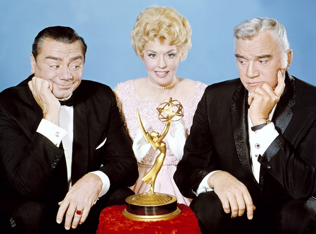 From left to right, Ernest Borgnine, Donna Douglas and Lorne Greene pose with an Emmy Award, with Borgnine and Greene looking at the award, in a studio portrait, at the Annual Primetime Emmy Awards, May 1964 