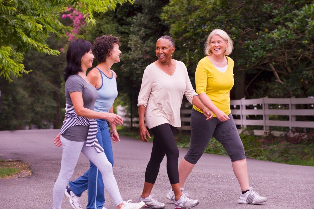 a group of women walking, which is a great exercise for women over 50