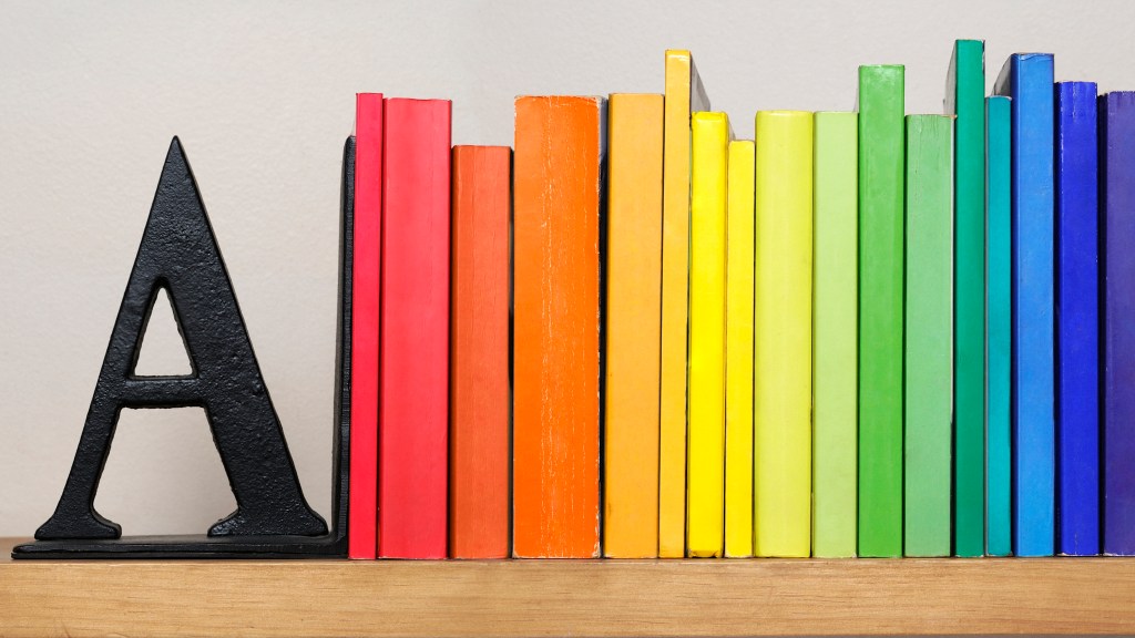 Home office organizing: Spectrum of colorful books between an A bookend