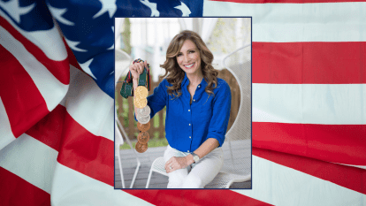 Former Olympian Shannon Miller smiles broadly while holding her seven Olympic medals and exudes resilience after having overcome setbacks