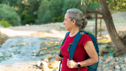 Woman walking outside with backpack