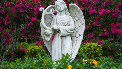 Garden statue of angel playing harp