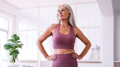 mature woman with a healthy gut microbiome exercising in workout clothes