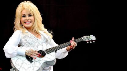 woman with guitar on stage; dolly parton musical