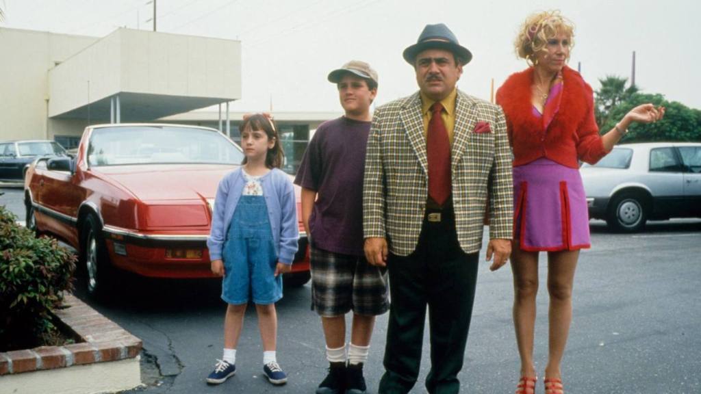 family standing by car; mara wilson young