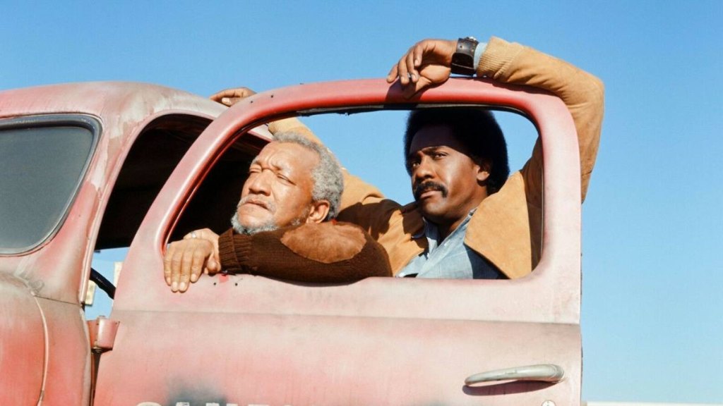 Redd Foxx and Demond Wilson in ‘Sanford and Son' (1974), getting in to their truck in a moment that…