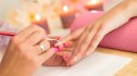 Woman getting polygel nails created in a nail salon