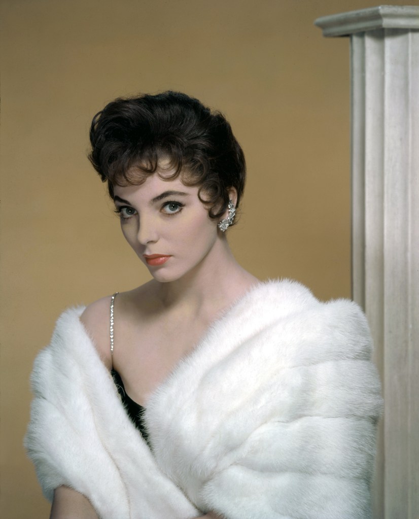 Joan Collins wearing fur coat in '50s
