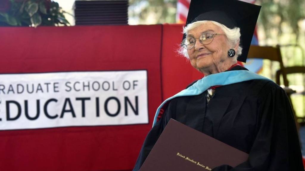 woman on stage with diploma; stanford